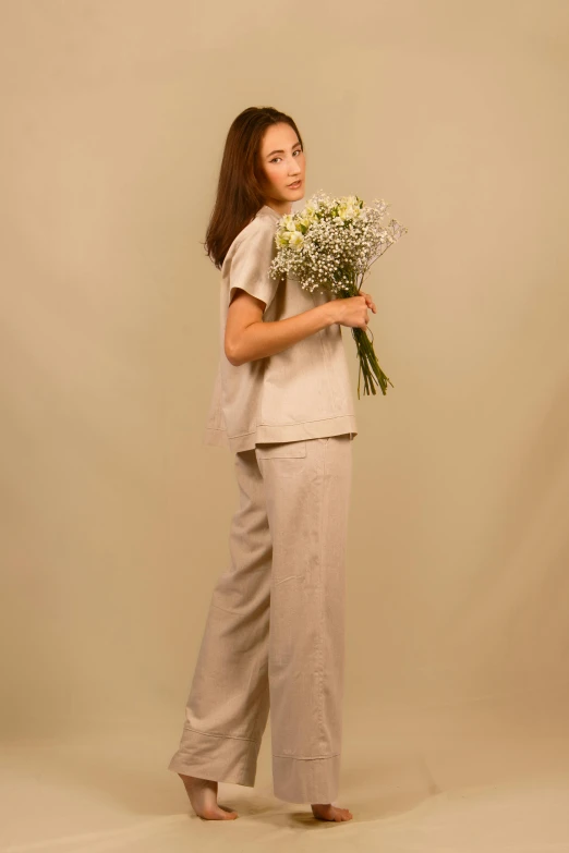 a girl is holding some flowers in her hand