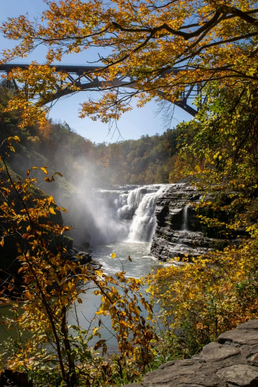 the water cascading out from a waterfall is pictured in the background