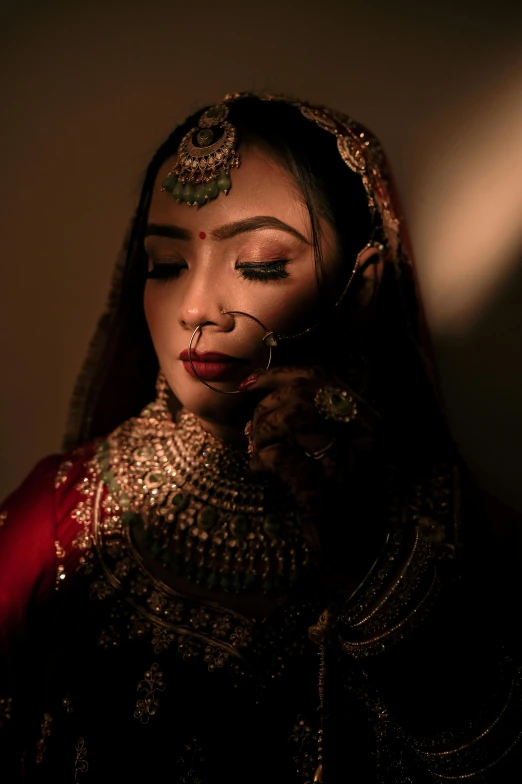 a woman is wearing a red outfit with an elaborate head piece