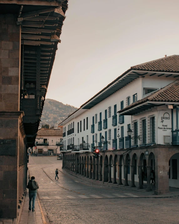 an old town center with two buildings and the people in the distance