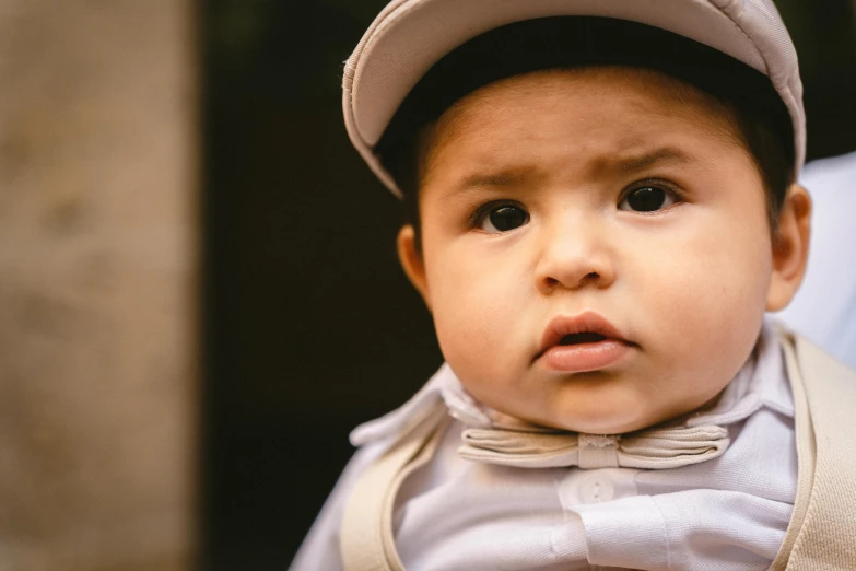 a baby wearing a hat on top of it's head