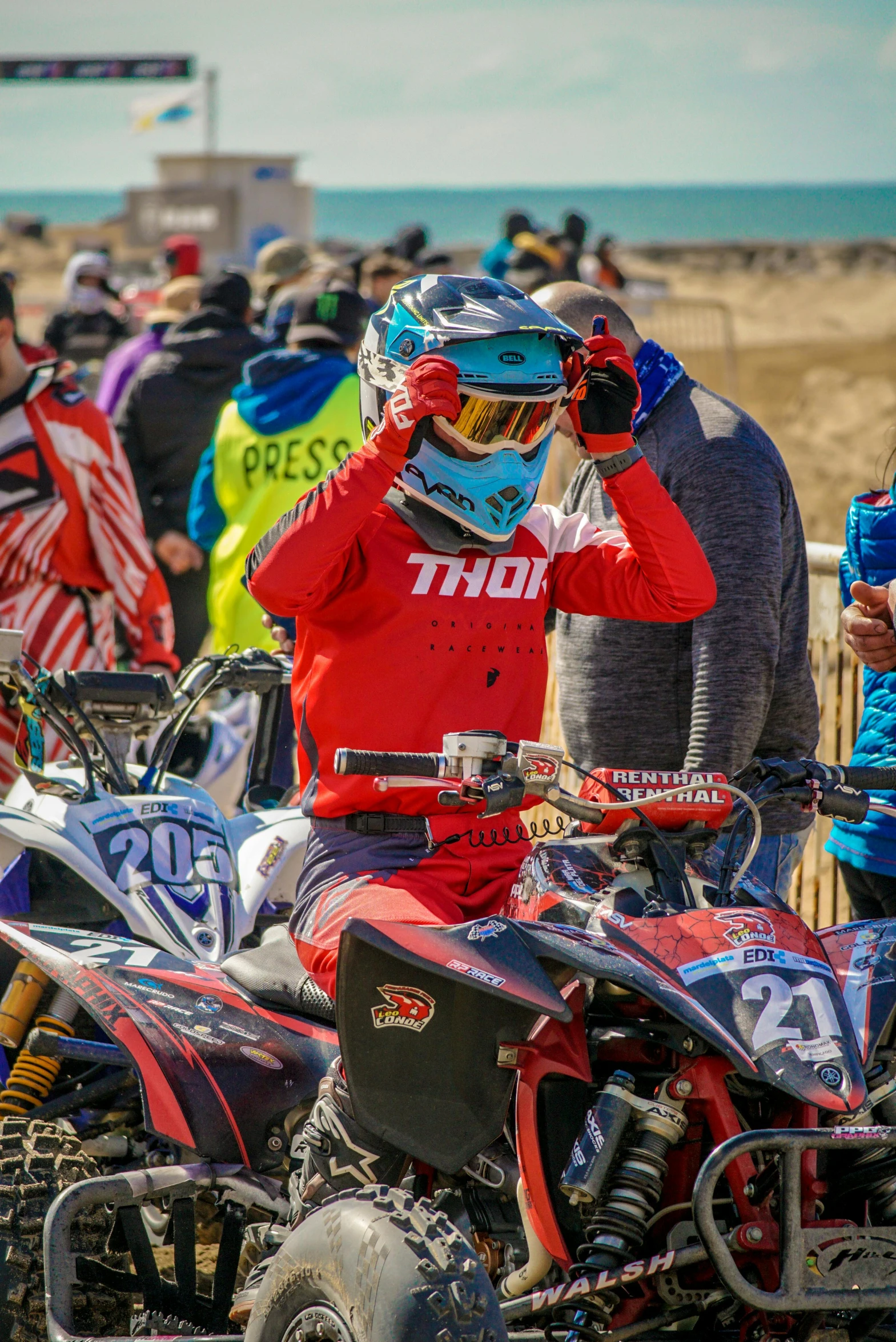 man on dirt bike with people behind him watching from stands