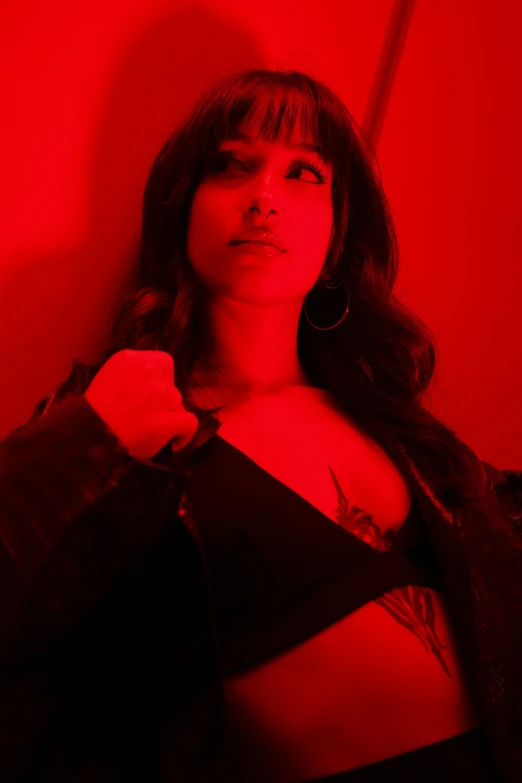 woman posing for picture in dark clothing with red light