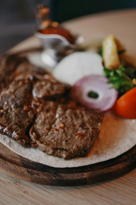 steak with onion and tomato on a plate