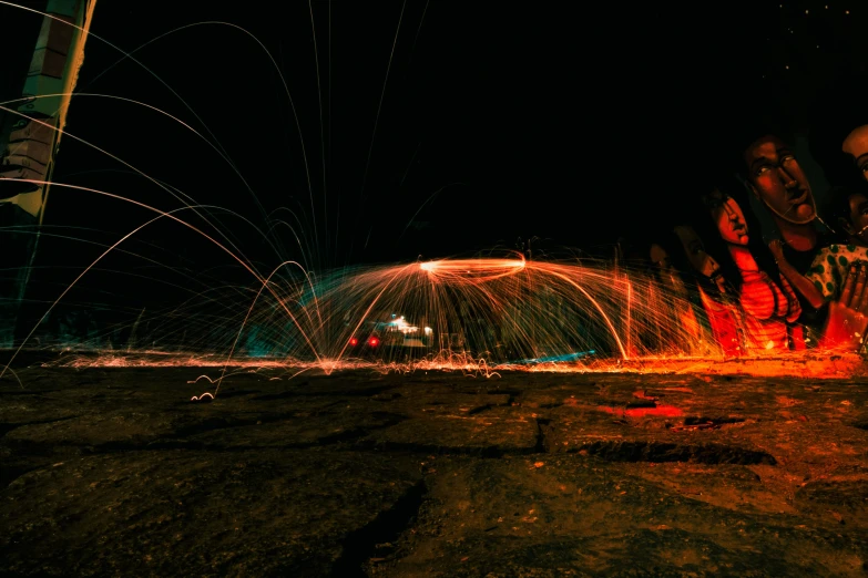 water and fireworks are lit up in the dark