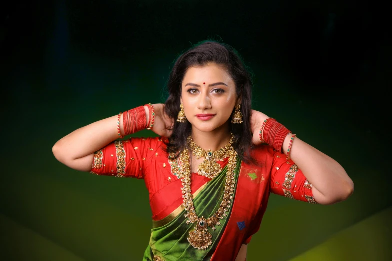 a beautiful indian woman posing with her hands on her head