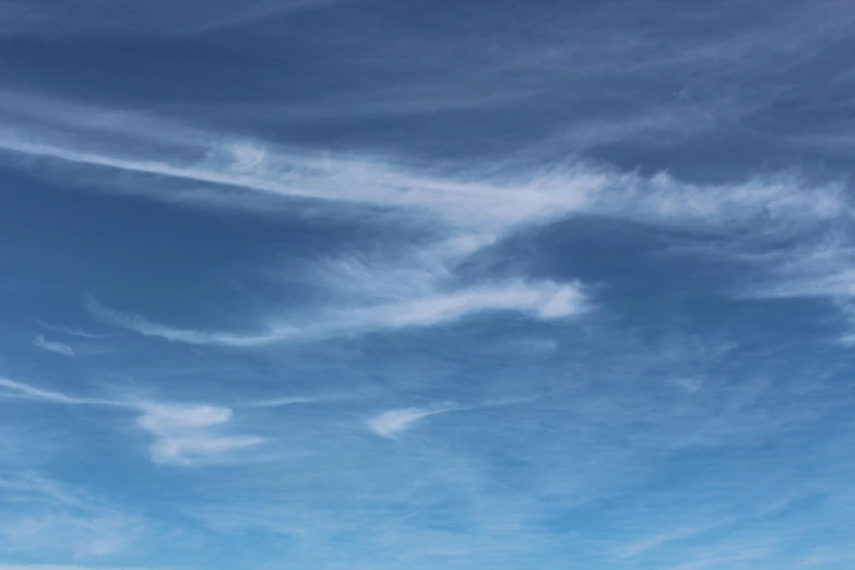 airplane with blue sky and clouds in background