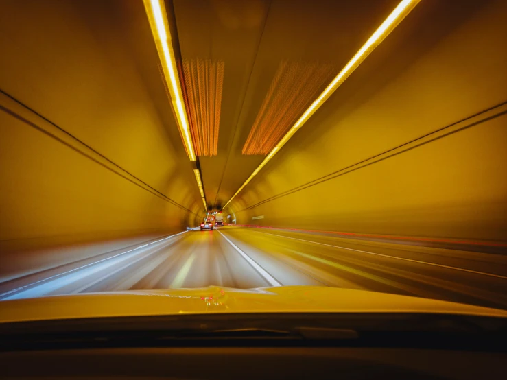 a car passing under an overpass at night time