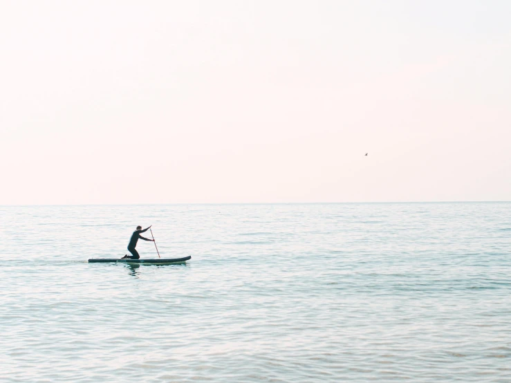 a person riding on a kayak on a body of water