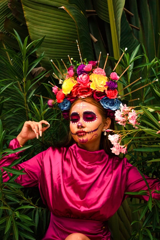 a girl with painted face and body in front of flowers