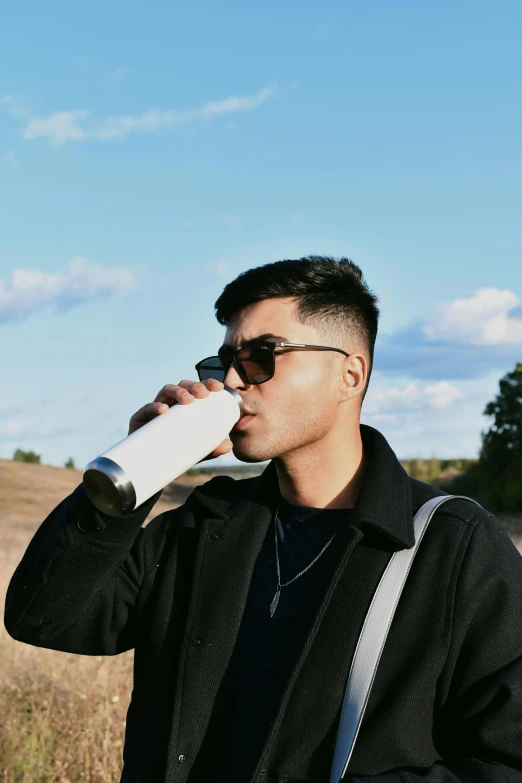 a man on the phone in a field with a camera