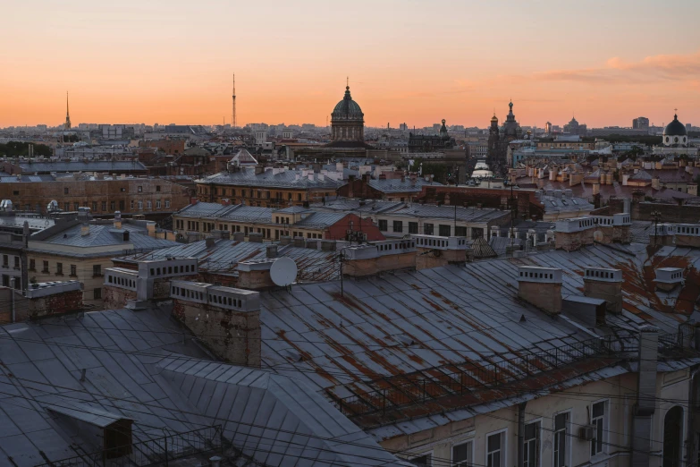 a view of a city at sunset with lots of old buildings