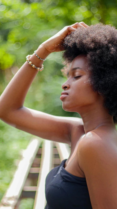 a woman holding her head with her hand while looking at soing