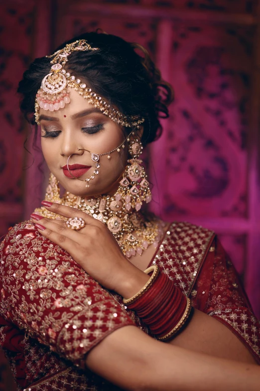 a young woman wearing gold jewelry holding onto her hand