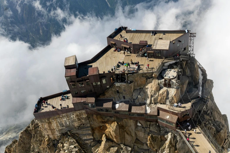 the top of a tall mountain with a building on it