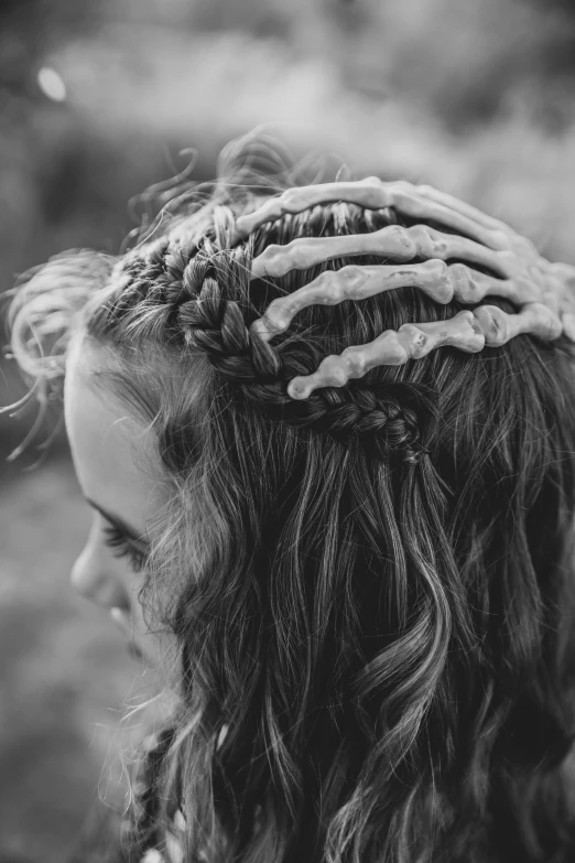 black and white pograph of a  with her hair pulled back