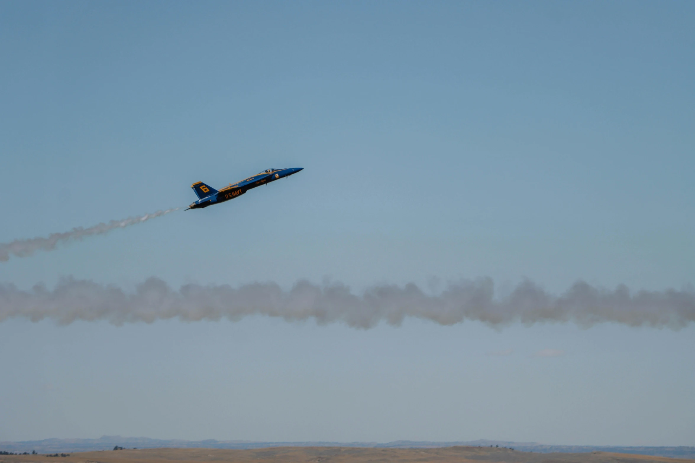 a fighter jet with smoke coming out is flying