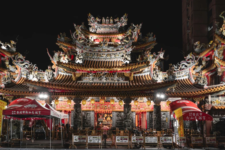 a large chinese structure with colorful lights inside