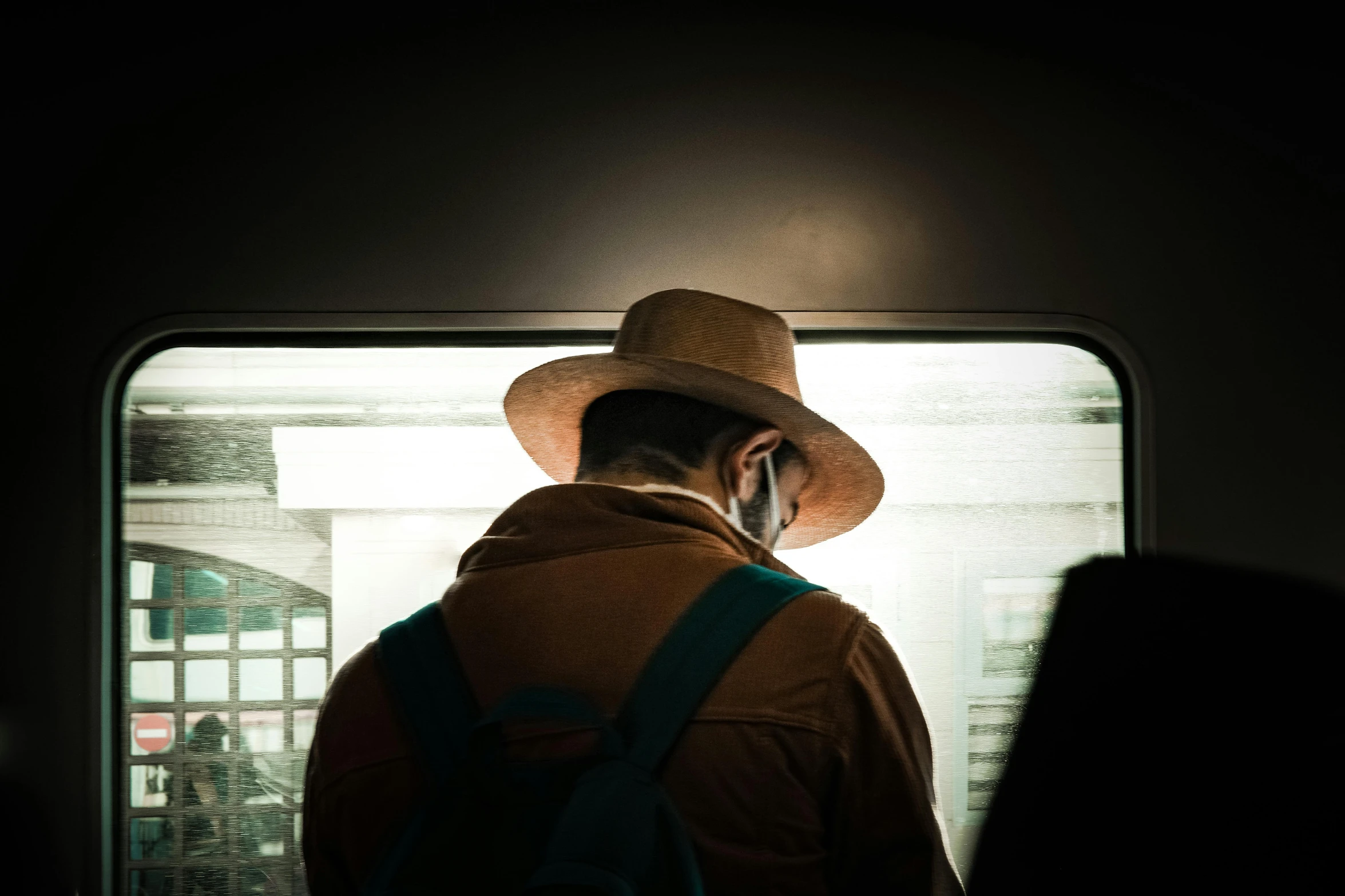 a man with backpack in a dark subway station