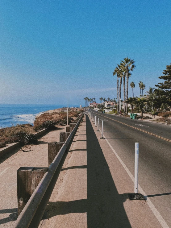 a large long line of street next to the ocean