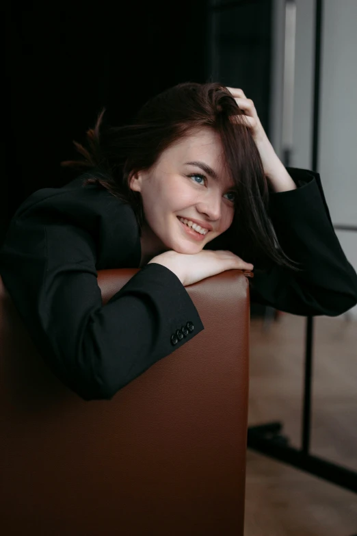 a woman leaning on top of a suitcase