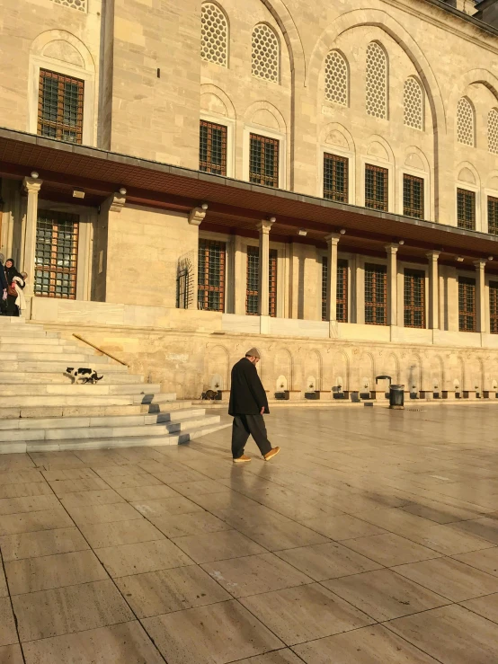 a person kneeling down in front of a building