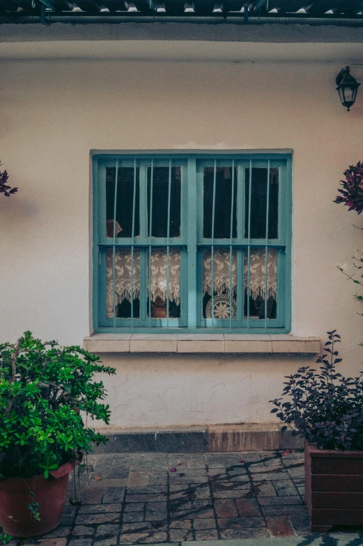 a view of a window from the ground in a courtyard area