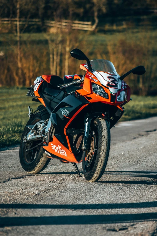 a close up of a motorcycle on a road near grass