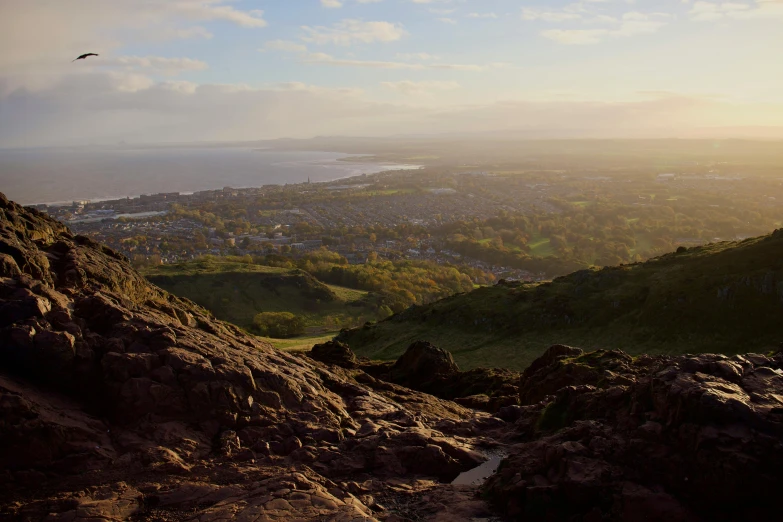 the view from top of a hill looking down on a small town