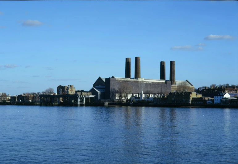 smoke stacks rising from buildings on a city pier