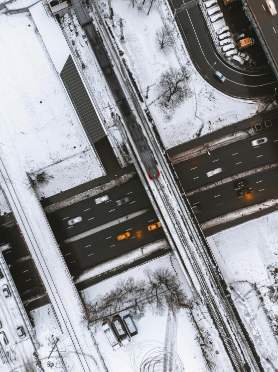 an overhead view of snow covered roadways and traffic lights