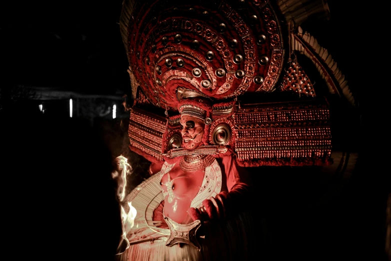 a statue on display with a red light behind it