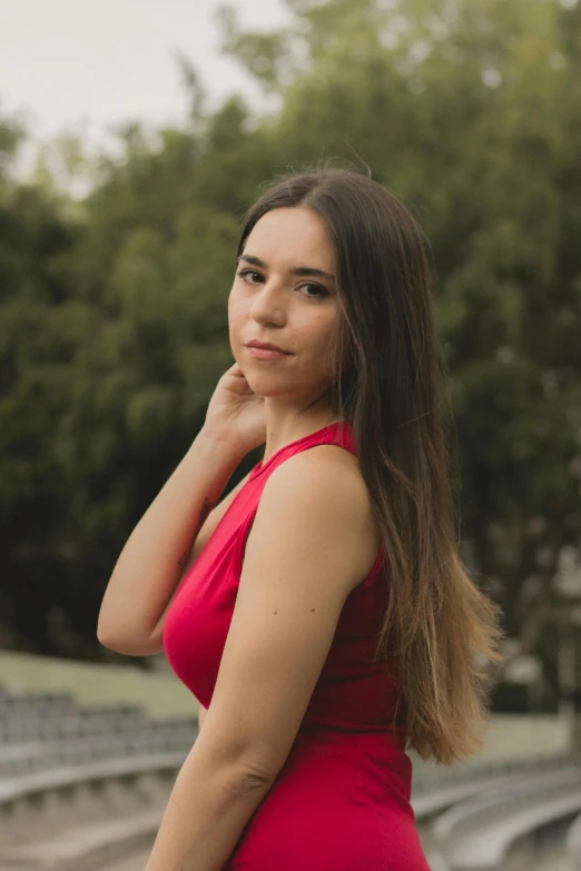 a woman with a red top posing for the camera