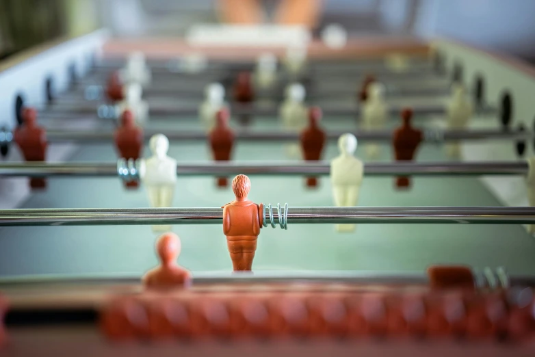 miniature plastic figures are arranged on a glass table