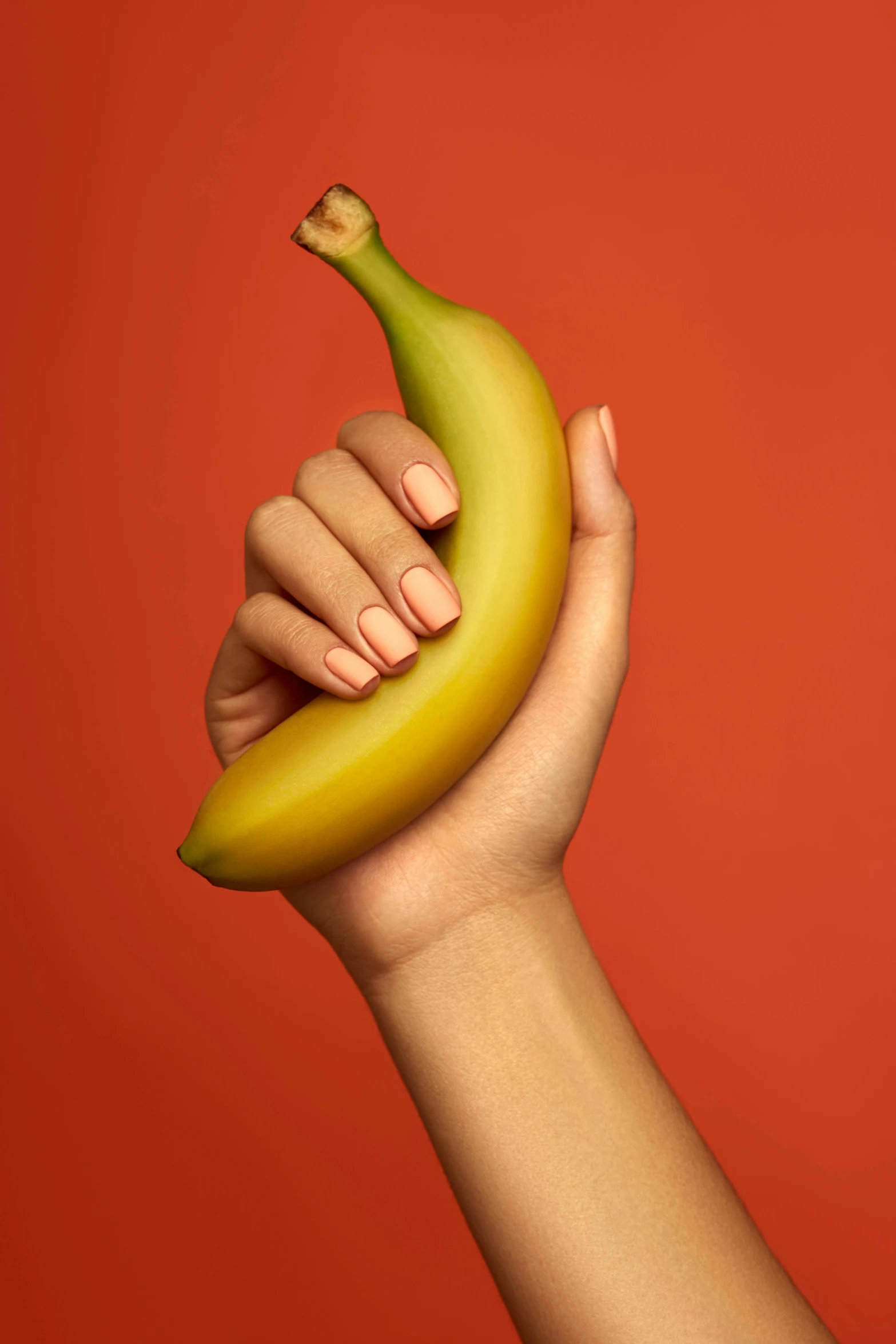 someone holding a banana up to their wrist