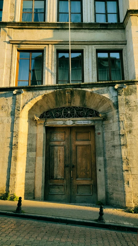 a street side view of an old building with a wooden door