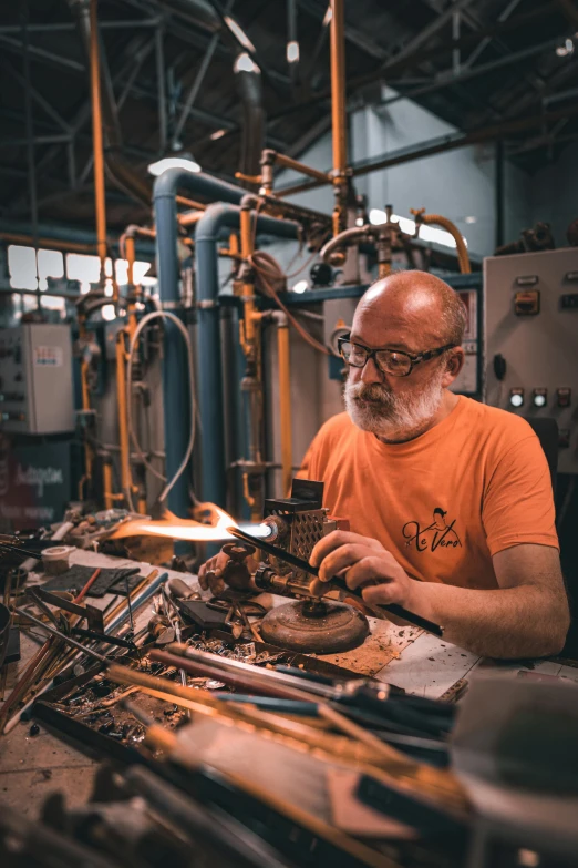 a man working in a metal industry with equipment