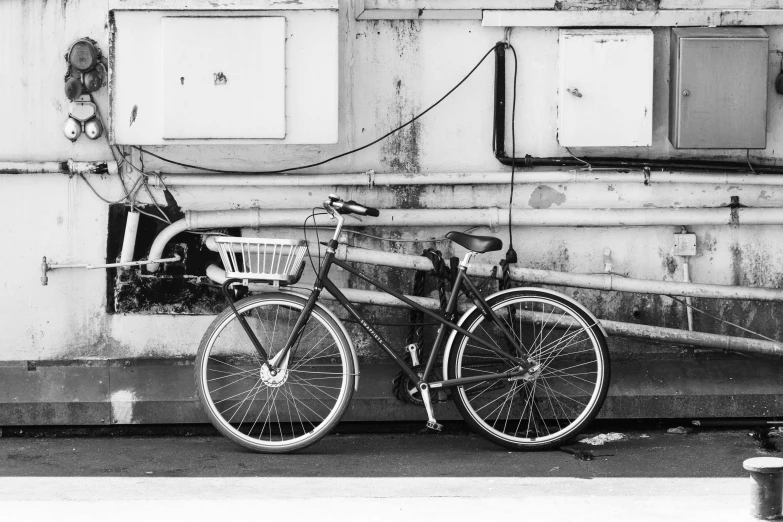 black and white pograph of a bike locked up in a station