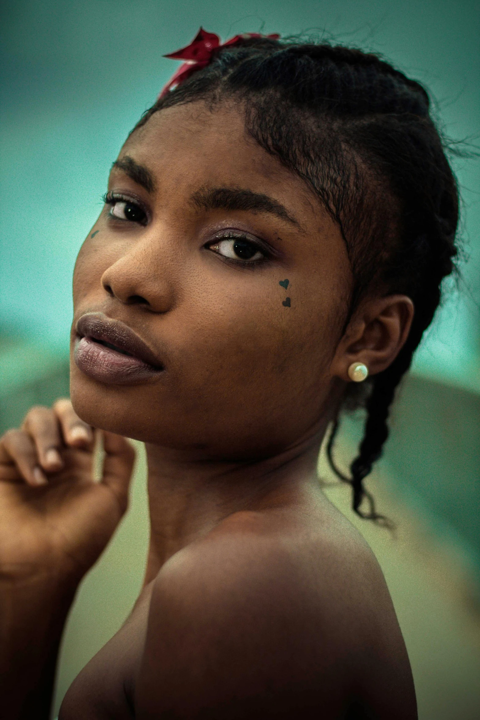 a girl with a small tattoo on her cheek and chest