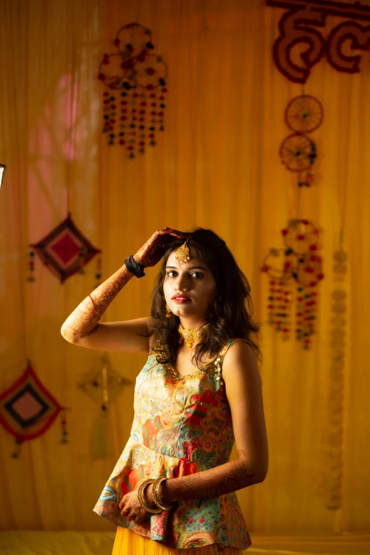 a woman is standing under a bright backdrop