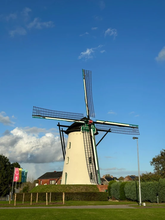 a windmill that is in a grassy field