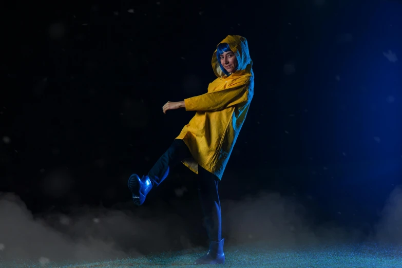 a person in a rain jacket doing some kind of dance