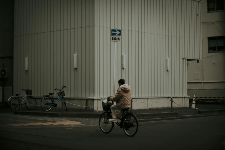 a person on a bike pulling on to a building