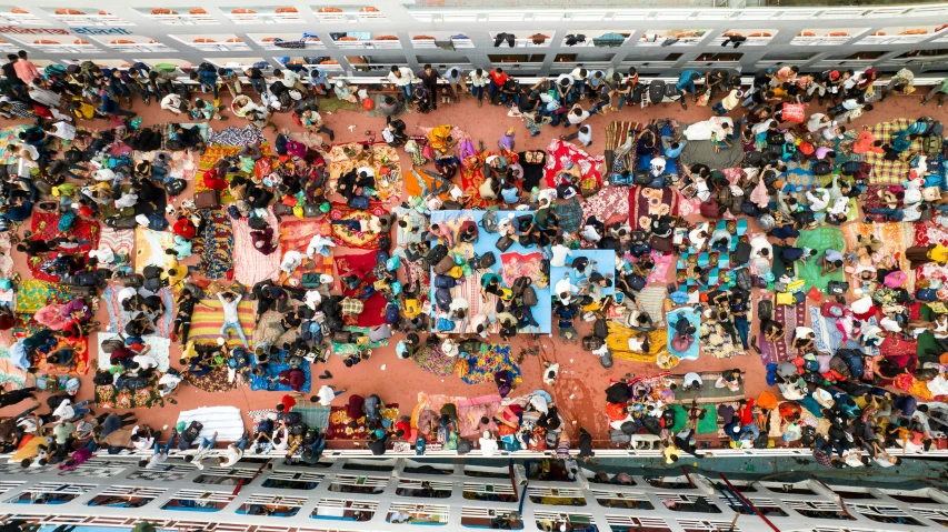 a large crowd of people standing next to each other on a building