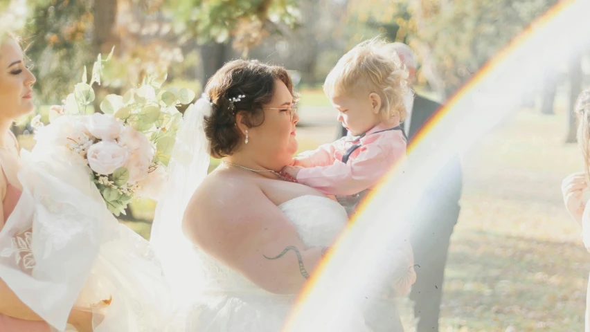 a little girl looks into her mother's eyes as the bride gets married