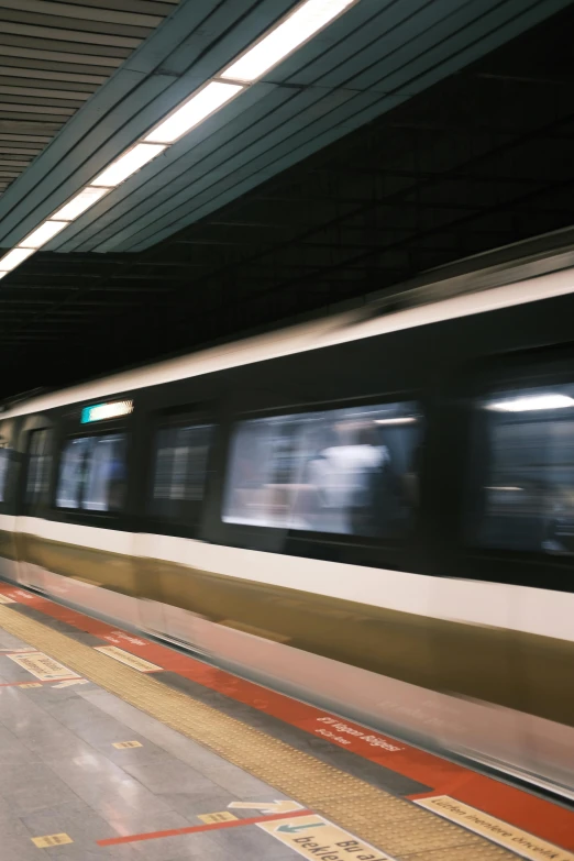 a subway in motion on the inside of an underground station