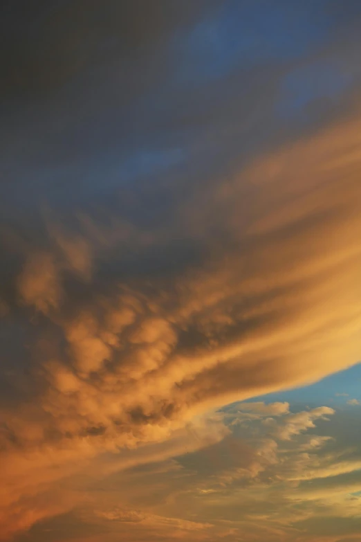 the sunset is shining brightly as the clouds glow in a cloudy sky