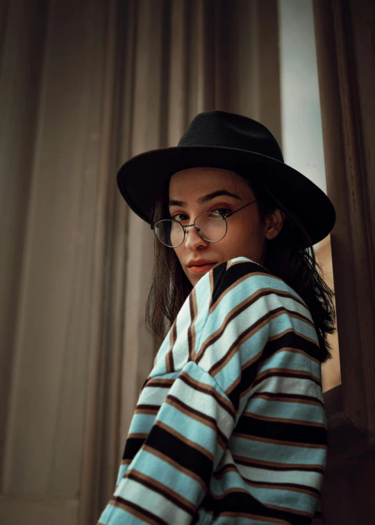 young woman wearing blue  top looking off camera