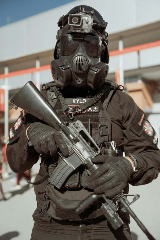an army man in full gear, holding an automatic rifle