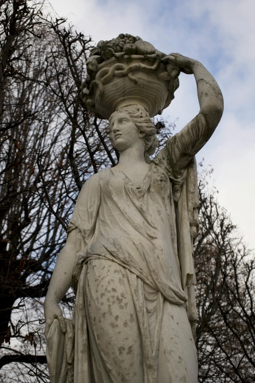 a statue with a basket on her head